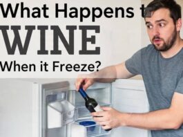 a guy putting a wine bottle in the freezer