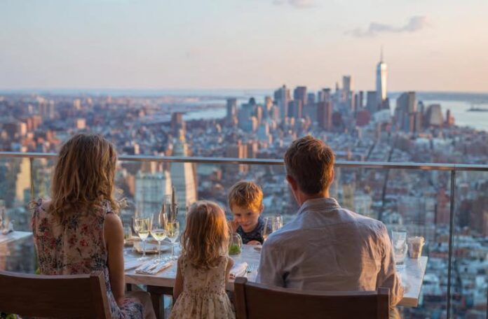Nyc Kiddo Bites: Top Kids-Friendly Restaurants In The Big Apple family eating at a Kids-Friendly Restaurants In nyc