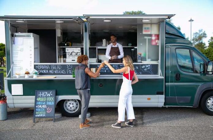 Event Catering Prospecting Checklist For Food Trucks Food truck owner reviewing an event catering prospecting checklist before contacting potential clients