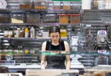How Restaurants Can Avoid Running Out of Essential Kitchen Supplies Restaurant kitchen staff checking inventory checklist against stocked shelves