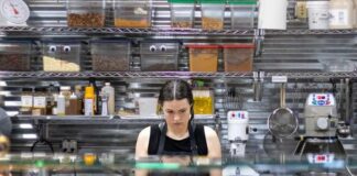 How Restaurants Can Avoid Running Out of Essential Kitchen Supplies Restaurant kitchen staff checking inventory checklist against stocked shelves