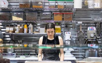 How Restaurants Can Avoid Running Out of Essential Kitchen Supplies Restaurant kitchen staff checking inventory checklist against stocked shelves
