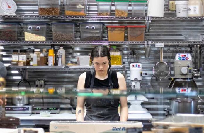 How Restaurants Can Avoid Running Out Of Essential Kitchen Supplies Restaurant kitchen staff checking inventory checklist against stocked shelves