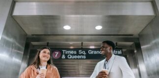 Why New Yorkers Take Their Coffee Seriously, Even at Work New Yorker holding a coffee cup while walking through the city