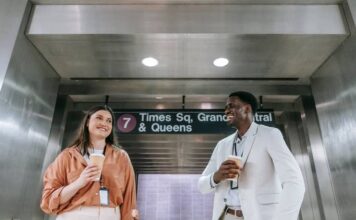 Why New Yorkers Take Their Coffee Seriously, Even at Work New Yorker holding a coffee cup while walking through the city