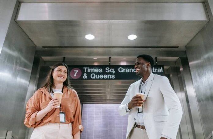 Why New Yorkers Take Their Coffee Seriously, Even At Work New Yorker holding a coffee cup while walking through the city
