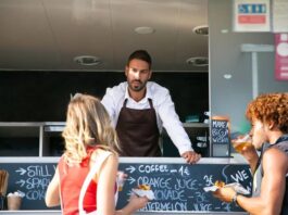 What Can Break a Food Truck Partnership Before the Menu Does Two business partners standing in front of their food truck