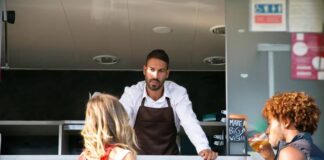 What Can Break a Food Truck Partnership Before the Menu Does Two business partners standing in front of their food truck