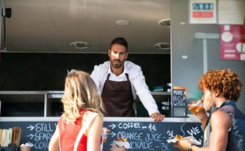 What Can Break a Food Truck Partnership Before the Menu Does Two business partners standing in front of their food truck